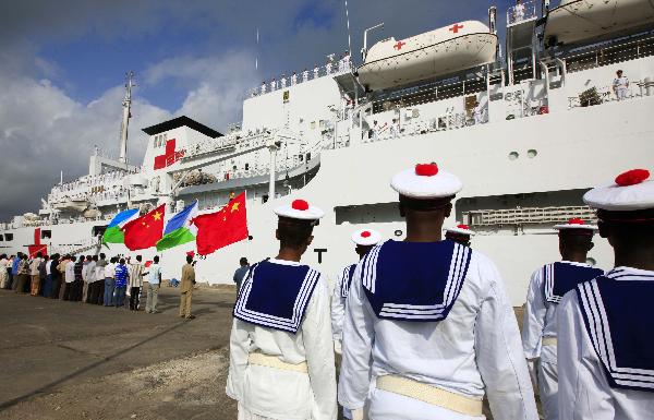 Djibouti navy soldiers salute in front of China's hospital ship Peace Ark at the port of Djibouti, Sept. 29, 2010.