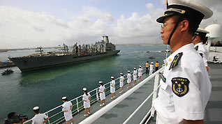 Crew members of China's hospital ship Peace Ark stand on the deck as the ship leaves the port of Djibouti, Sept. 29, 2010. The Peace Ark left for Kenya on Wednesday after providing medical services for local residents in Djibouti for a week.