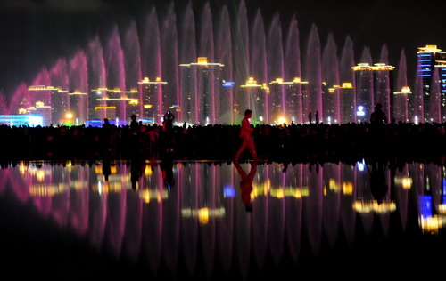 Music fountains are illuminated by colorful laser lights at the Shanghai World Expo to celebrate the National Day on Oct 1st, 2010.