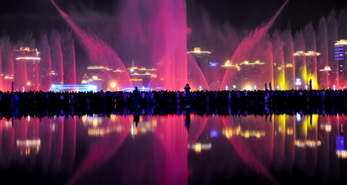 Music fountains are illuminated by colorful laser lights at the Shanghai World Expo to celebrate the National Day on Oct 1st, 2010.