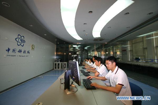 This undated photo shows staff members working at the China Science and Technology Network, which offers technology supports for the project. 