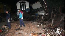 Rescuers work at the site of a train crash accident in Petarukan of Indonesia's Central Java Oct. 2, 2010.