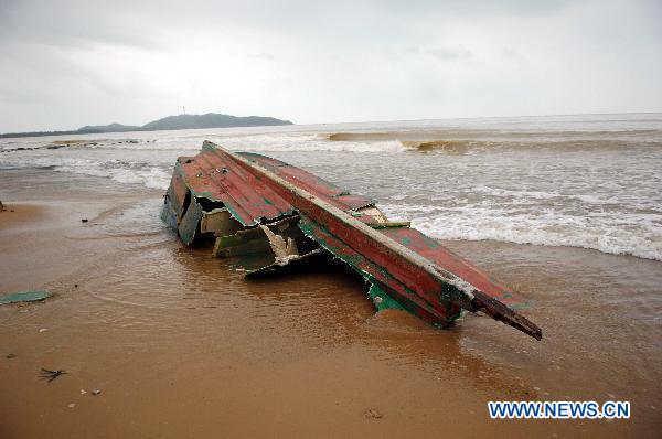 Photo taken on Oct. 6, 2010 shows a fishing boat shattered by heavy rains and waves on a beach in Lingshui County, south China&apos;s Hainan Province.