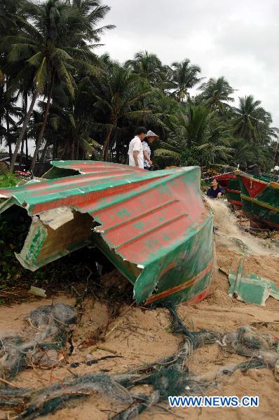 Photo taken on Oct. 6, 2010 shows remains of a fishing boat shattered by heavy rains and waves on a beach in Lingshui County, south China&apos;s Hainan Province.