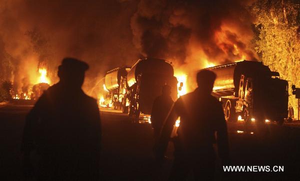 Fire rages after an attack on NATO oil tankers in northwest Pakistan's Nowshera Oct. 6, 2010. At least 30 NATO oil tankers were burned following an attack on Wednesday night by unknown gunmen in Nowshera, local media reported.