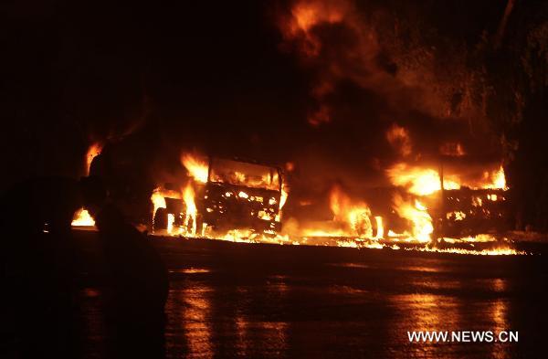 Fire rages after an attack on NATO oil tankers in northwest Pakistan's Nowshera Oct. 6, 2010. At least 30 NATO oil tankers were burned following an attack on Wednesday night by unknown gunmen in Nowshera, local media reported.