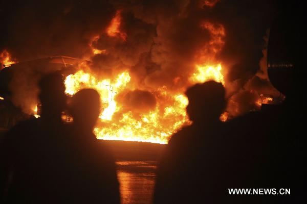 Fire rages after an attack on NATO oil tankers in northwest Pakistan's Nowshera Oct. 6, 2010. At least 30 NATO oil tankers were burned following an attack on Wednesday night by unknown gunmen in Nowshera, local media reported. 