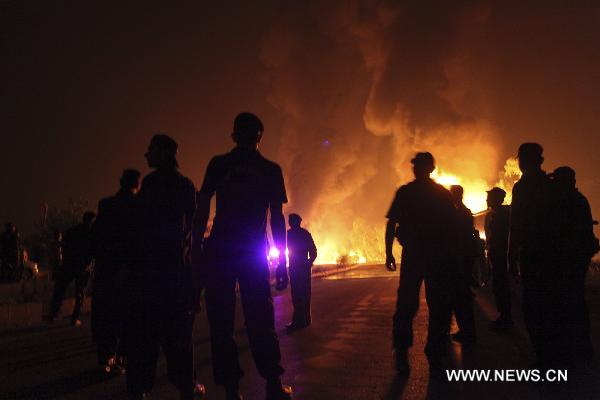 Security forces cordon off the area after an attack on NATO oil tankers in northwest Pakistan's Nowshera Oct. 6, 2010. At least 30 NATO oil tankers were burned following an attack on Wednesday night by unknown gunmen in Nowshera, local media reported. 