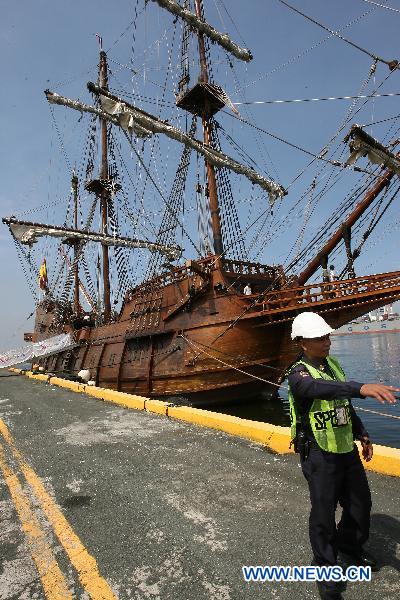 A pier security walks in front of the Spanish galleon replica Andalucia docked on Pier 13 in Manila, the Philippines, Oct. 6, 2010. 