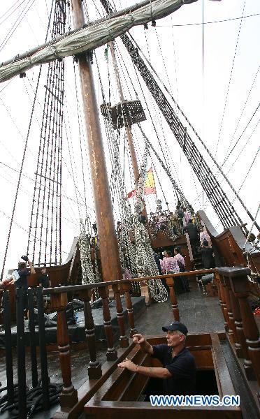 A crew member walks upstairs from inside the Spanish galleon replica Andalucia docked on Pier 13 in Manila, the Philippines, Oct. 6, 2010.