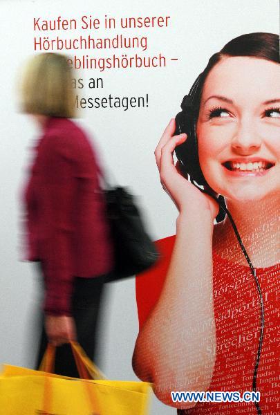 A visitor walks past a poster during the 62nd Frankfurt International Book Fair in Frankfurt, Germany, Oct. 6, 2010. 