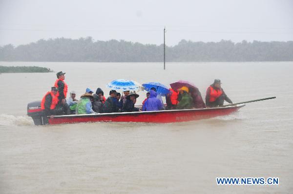 Villagers trapped at the Sanjiang farm are transfered on a speed boat in Haikou, capital of south China&apos;s Hainan Province, Oct. 7, 2010. 