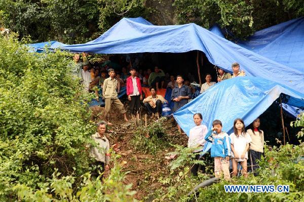 Locals take refuge in makeshift tents in Quang Binh, central Vietnam, on Oct. 7, 2010. 