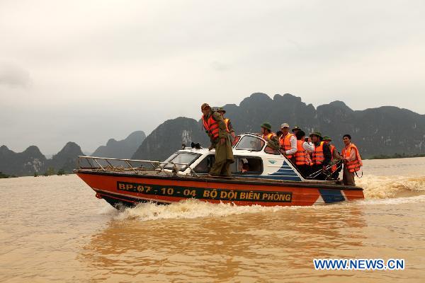 Rescuers sail in floodwaters in Quang Binh, central Vietnam, on Oct. 7, 2010.