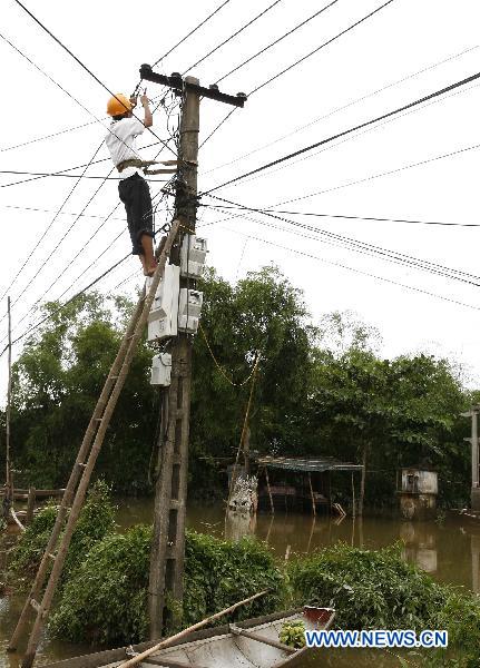 A worker repairs electricity device in Quang Binh, central Vietnam, on Oct. 7, 2010. 