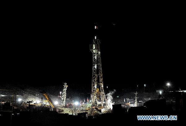 Photo taken on Oct. 6, 2010, shows the Rig 421 drill (rear) helping dig an escape hole for the 33 miners still trapped deep underground at the San Jose Mine, 800 km north of Chilean capital Santiago.