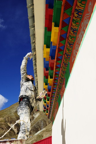 A mason puts the finishes touches to a newly-built house in Yushu County, northwest China's Qinghai Province, on Thursday Oct 7, 2010.