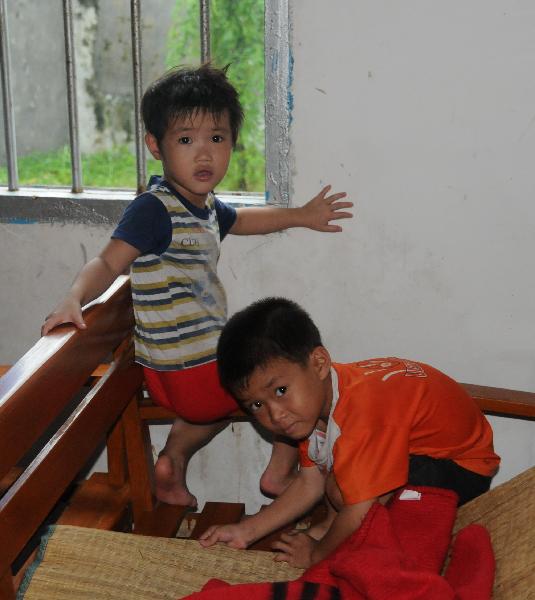 Two boys play at a resettlement place in Wanning, south China's Hainan Province, Oct. 8, 2010. 