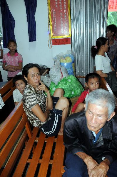 Villagers rest at a resettlement place in Wanning, south China's Hainan Province, Oct. 8, 2010.