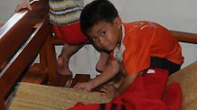 Two boys play at a resettlement place in Wanning, south China's Hainan Province, Oct. 8, 2010.