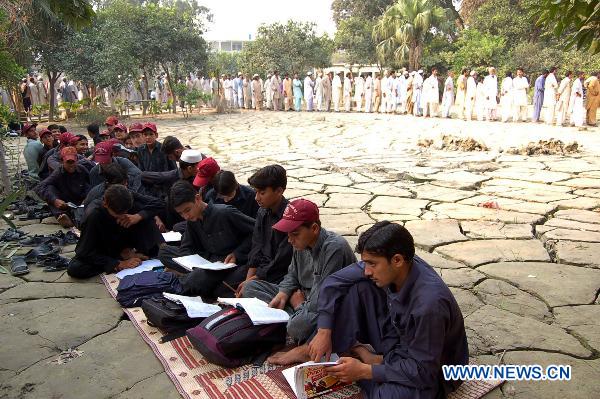 Students affected by floods study at a temporary school in northwest Pakistan&apos;s Nowshera Oct. 8, 2010.