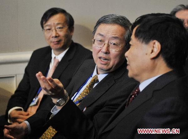 Governor of the People&apos;s Bank of China (PBOC) Zhou Xiaochuan (C), Vice Governor of the POBC Yi Gang (L) and Chinese Vice Finance Minister Zhu Guangyao (R) attend the opening ceremony of the Plenary Session of the Annual Meetings of the International Monetary Fund (IMF) and World Bank in Washington, the United States, Oct. 8, 2010.