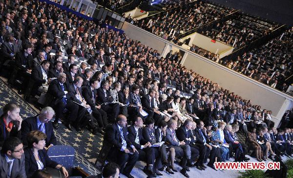 Delegates attend the opening ceremony of the Plenary Session of the Annual Meetings of the International Monetary Fund (IMF) and World Bank in Washington, the United States, Oct. 8, 2010. 