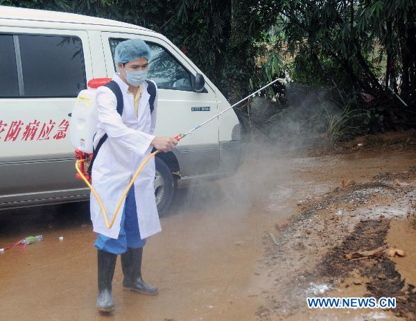 A medic sprays disinfectant in a village of Wenchang, south China's Hainan Province, Oct. 10, 2010. 