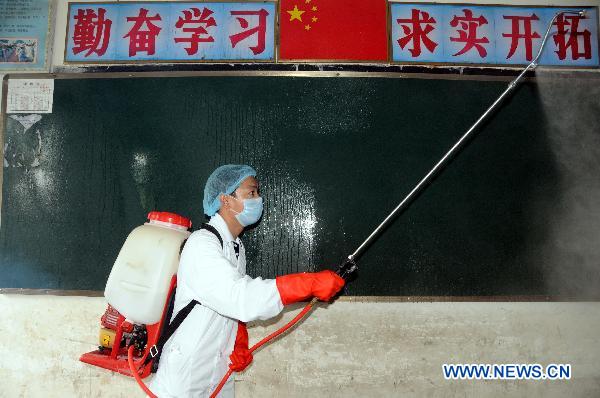 A medic sprays disinfectant in a village of Wenchang, south China's Hainan Province, Oct. 10, 2010.