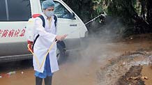 A medic sprays disinfectant in a village of Wenchang, south China's Hainan Province, Oct. 10, 2010.