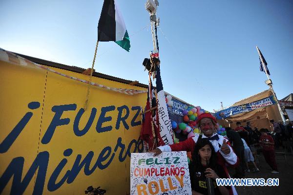 A clown performs for relatives of the 33 trapped miners in San Jose mine, 800 km north of the Chilean capital Santiago, on Oct. 9, 2010.