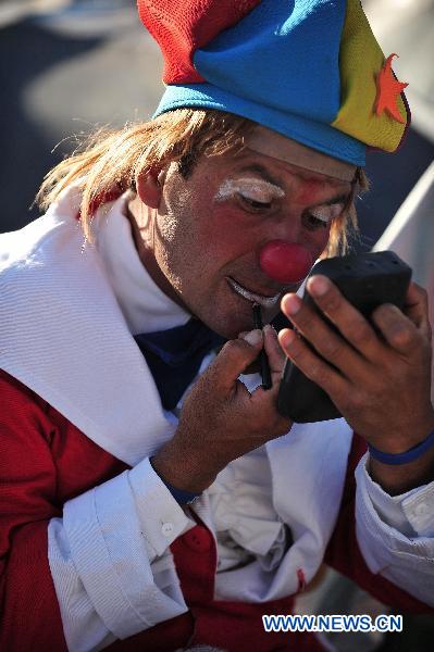 A clown makes up before he performs for relatives of the 33 trapped miners in San Jose mine, 800 km north of the Chilean capital Santiago, on Oct. 9, 2010.