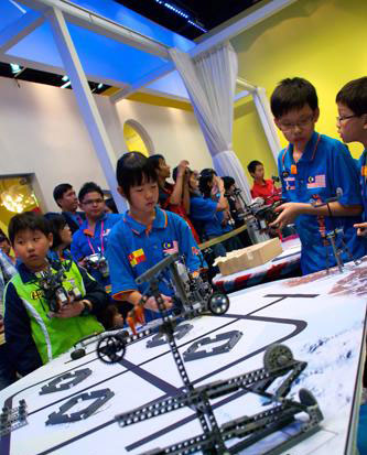 A Chinese child is seen behind a robot in the games.[