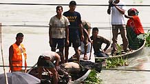 The rescue team salvages a body from the river at the accident scene in Savar, suburb of Bangladesh's capital Dhaka, on Oct.11, 2010.