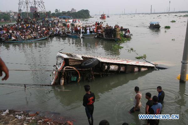 The sunken bus is pulled out of the river in Savar, the suburbs of Dhaka, capital of Bangladesh, Oct. 12, 2010. 
