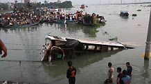 The sunken bus is pulled out of the river in Savar, the suburbs of Dhaka, capital of Bangladesh, Oct. 12, 2010.