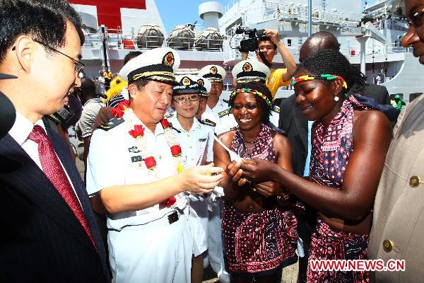 Bao Yuping (2nd L), commander of hospital ship Peace Ark of the Navy of the Chinese People's Liberation Army, is greeted upon the arrival of the Chinese navy hospital ship Peace Ark in Mombasa, Kenya, on Oct. 13, 2010.