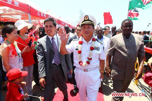 Bao Yuping (C, front), commander of hospital ship Peace Ark of the Navy of the Chinese People's Liberation Army, waves upon the arrival of the Chinese navy hospital ship Peace Ark in Mombasa, Kenya, on Oct. 13, 2010.