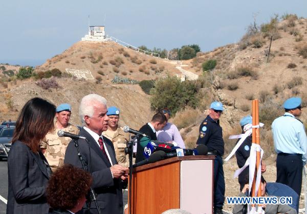 Turkish Cypriot leader Dervis Eroglu speaks at the opening ceremony for the Limnitis/Yesilirmak crossing, the 7th along the 180-km-long UN-controlled buffer zone in Cyprus, Oct. 14, 2010.