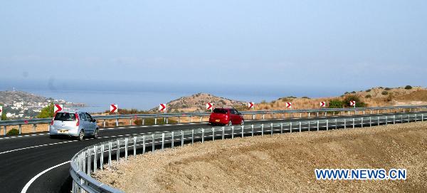 Cars travel on the newly upgraded road leading to the Limnitis/Yesilirmak crossing, the 7th along the 180-km-long UN-controlled buffer zone in Cyprus, Oct. 14, 2010. 