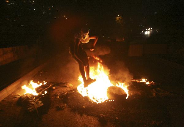 A Palestinian youth jumps over a fire during the clash with Israeli border police in the East Jerusalem neighbourhood of Silwan Oct. 17, 2010.