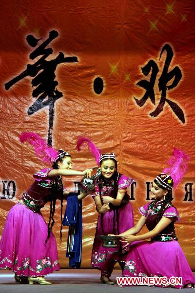 Dancers of China's Xinjiang Returned Overseas Chinese Federation Performing Art Troupe perform in Almaty, Kazakhstan, Oct. 18, 2010.