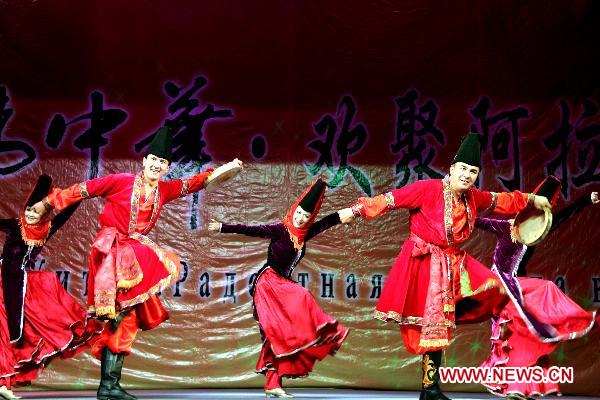 Dancers of China's Xinjiang Returned Overseas Chinese Federation Performing Art Troupe perform in Almaty, Kazakhstan, Oct. 18, 2010. 