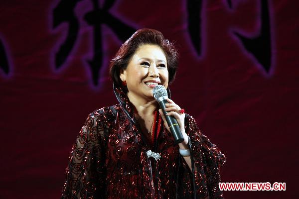 An actress of China's Xinjiang Returned Overseas Chinese Federation Performing Art Troupe performs in Almaty, Kazakhstan, Oct. 18, 2010.
