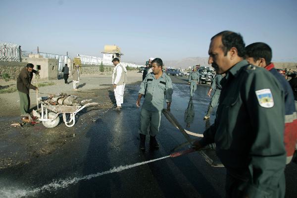 Police clean up the site of a blast in Herat, western Afghanistan, on Oct. 18, 2010. 