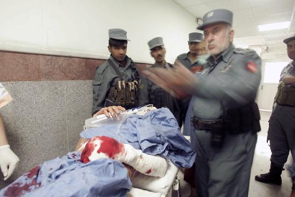 A man injured in a blast is taken to a hospital in Herat, western Afghanistan, on Oct. 18, 2010.