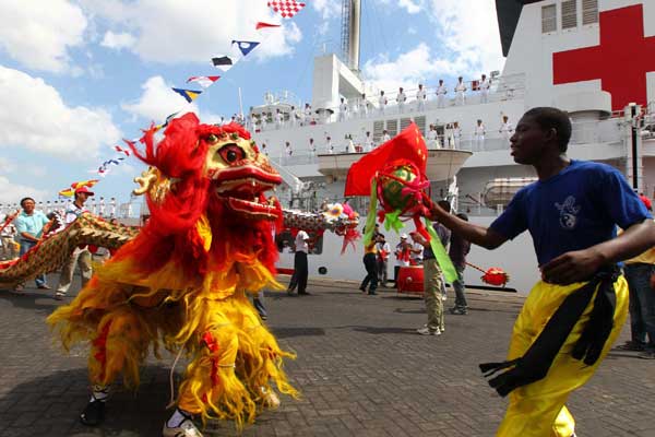 Local residents perform lion dances to welcome the Chinese navy hospital ship Peace Ark, Oct 19, 2010.