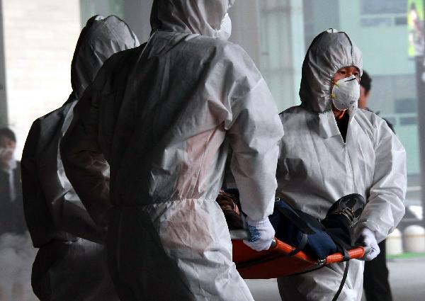 Medical staff carry an 'injured person' while taking part in the anti-terror exercises simulating a chemical attack in Seoul, South Korea, on Oct. 20, 2010. The drills came ahead of the G20 summit to be held in South Korea on Nov. 11-12. 