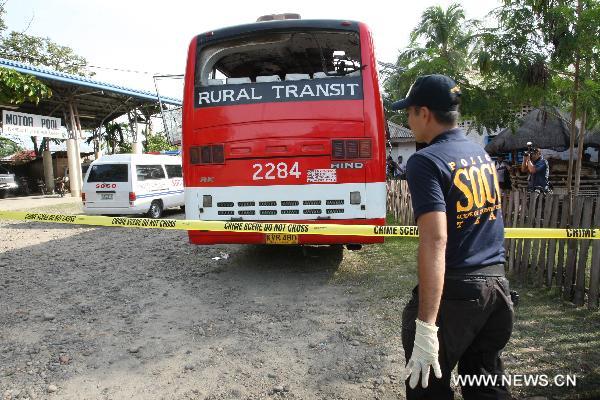 Policemen investigate inside a bus in which an explosive device went off in Dalapitan, Matalam town in the province of North Cotabato, Philippines, Oct. 21, 2010. 