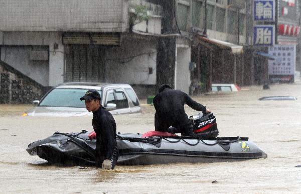 Rescuers work in a flooded street in Ilan County, southeast China's Taiwan, Oct. 21, 2010. Parts of Ilan county suffered from storm-triggered flood as typhoon Megi approached Taiwan on Thursday.